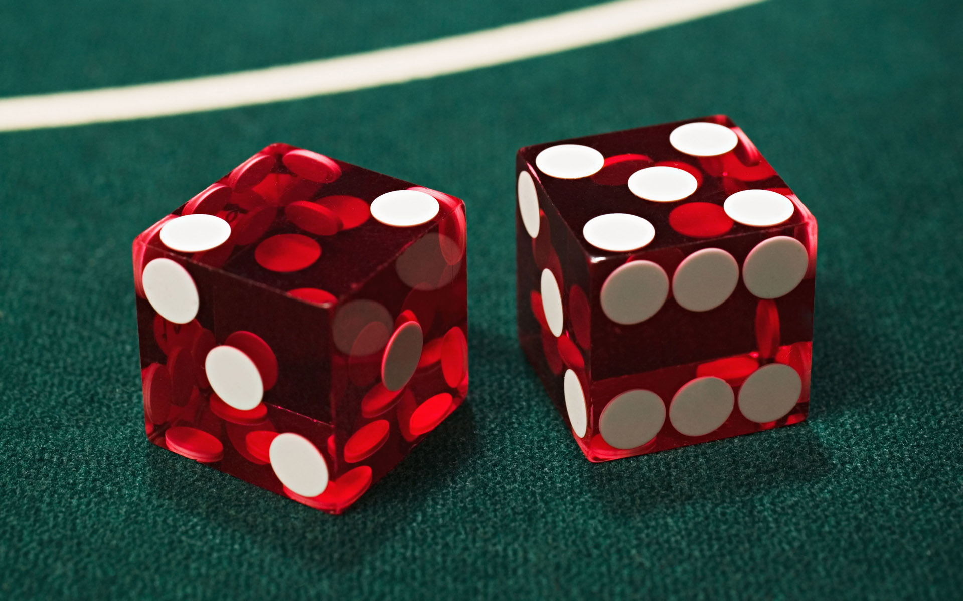 Two dice on a green craps table